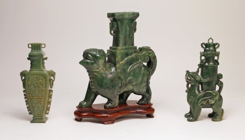 THREE CHINESE GREEN HARDSTONE CARVINGS,: 20th Century, including a guardian bird with an urn on its back, h. 10 ½", a guardian dog with a lidded urn on its back, h. 9", and a lidded vase with tree motif, h. 8 ½"
