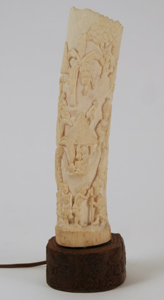 ANTIQUE CARVED IVORY AFRICAN TUSK: W/CONFORMING CVD.WOODEN BASE, CONVERTED TO NIGHT LITE, SGD. ON IVORY BASE, H. 13"