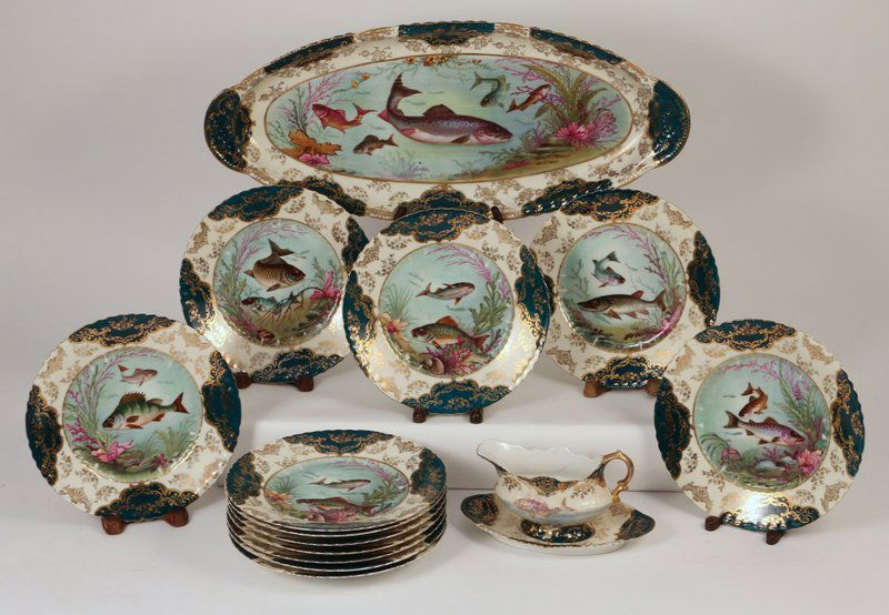 AUSTRIAN FISH SERVICE,: including 12 plates, 1 platter (20 ½"), and a sauce boat with underplate (both with damage)