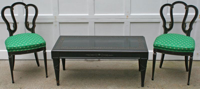 DARK GREEN NEOCLASSICAL EXTENSION COFFEE TABLE: with two similar black parcel-gilt side chairs, 20th Century, the coffee table with ormolu mounts, H: 18" W: 42" D: 20", the chairs: H: 34" SH: 18" W: 18", the table with missing pieces of ormolu at f