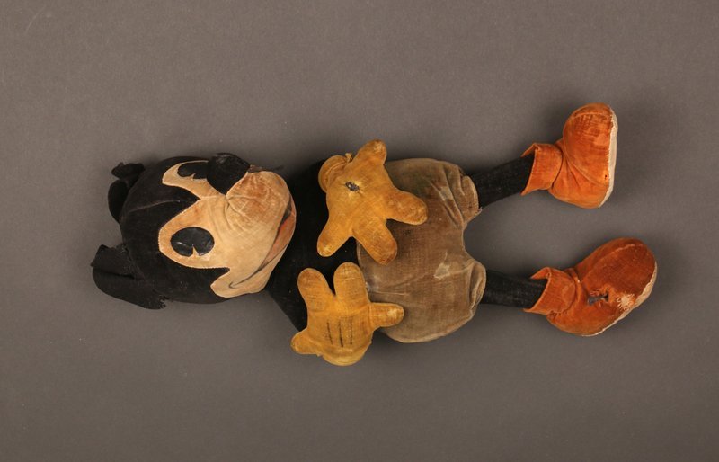 EARLY STEIFF MICKEY MOUSE DOLL: © Walt Disney, Germany, early pie-eyed four finger version, felt padded shoes, ear button ,with tears and damage at foot, h. 14"