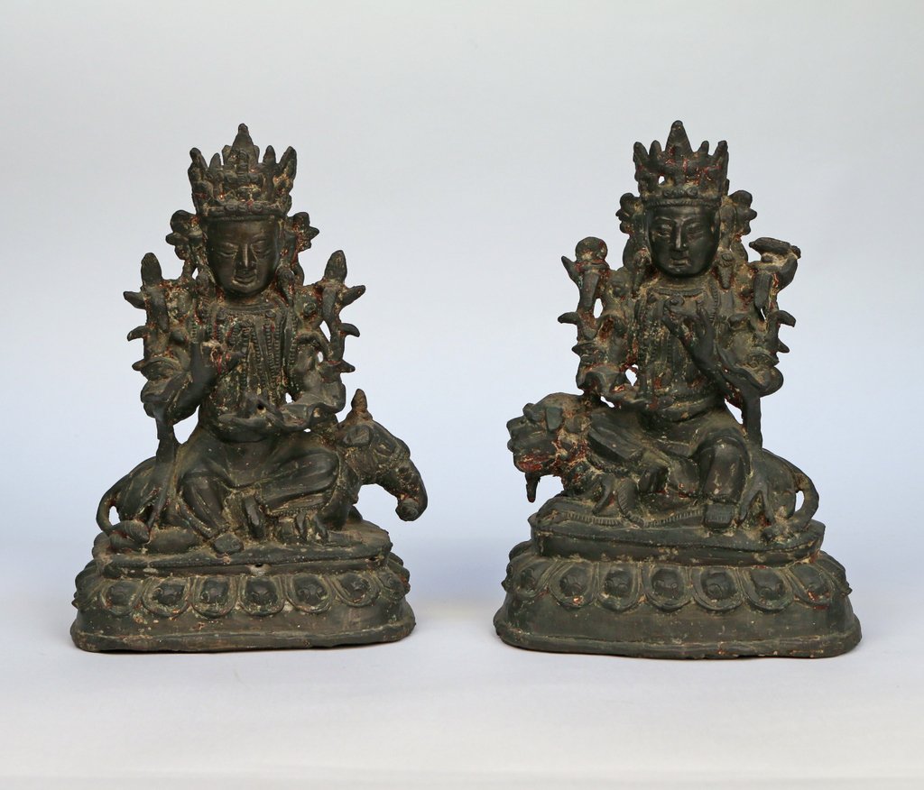 PAIR CHINESE BRONZE BUDDHIST DEITIES: both seated in the royal ease pose, including a figure of Manjusri atop a lion and his partner figure Samantabhadra atop an elephant, both bearing remnants of gilding and polychrome, h. 8 7/8”, w. 6