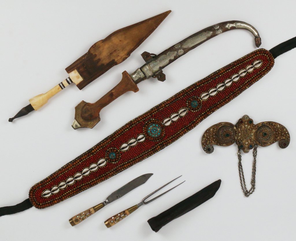 FIVE EASTERN DRESSING ITEMS: Including a dagger with a curved scabbard and wooden handle, 17 3/4" long; a dagger with a hide sheath and carved bone handle, 16 1/2"; a bead, shell, and turquoise belt, 24" (the beadwork); a pair of