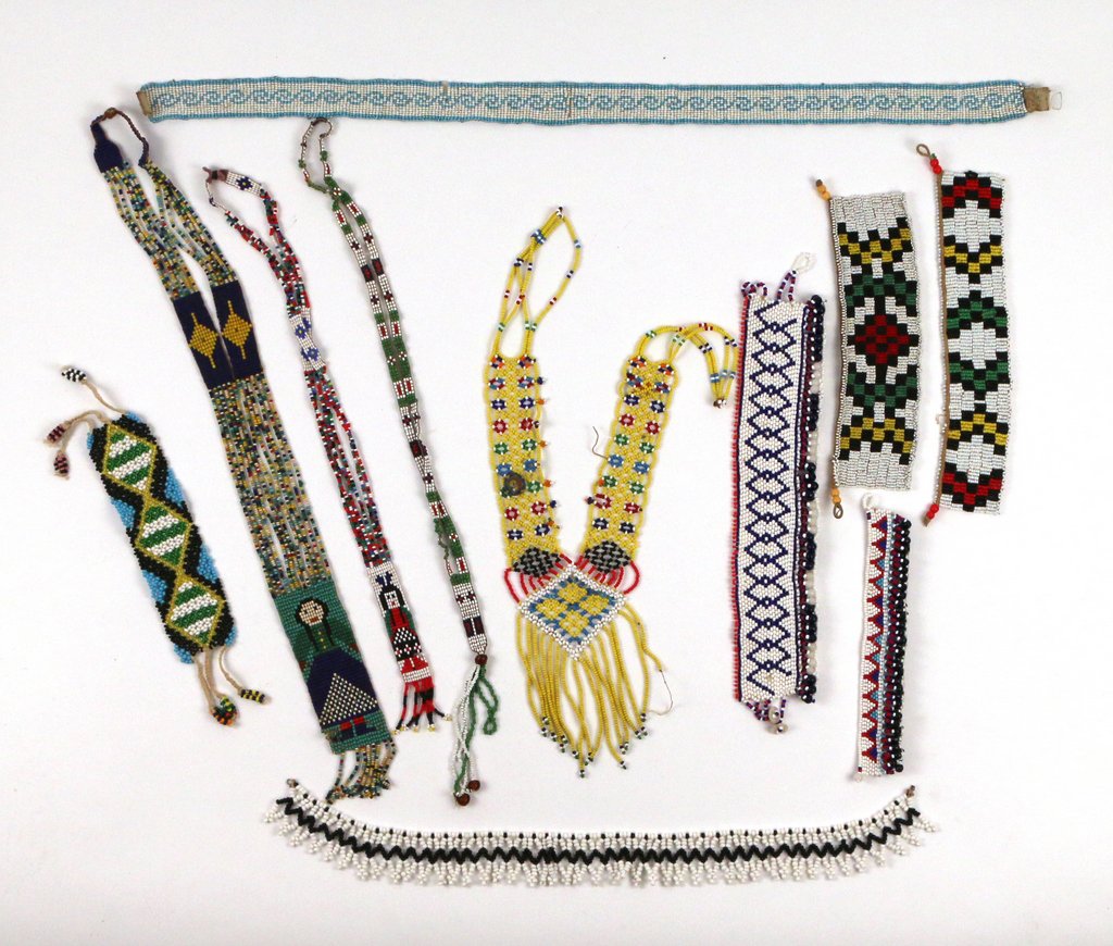 LOT OF NATIVE AMERICAN JEWELRY & BEADWORK: including 11 pieces of beadwork (5 necklaces, 6 straight bands); and approx. 33 pins and other, most inset with turquoise