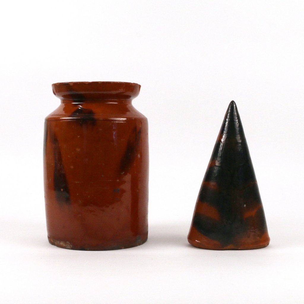 (2pc) REDWARE POTTERY: including a crock pinched at the neck and with manganese spots, h. 9" (with chips at rim and flakes in glaze at shoulder); plus a wall pocket of cone shape, h. 8" (chips at rim)
