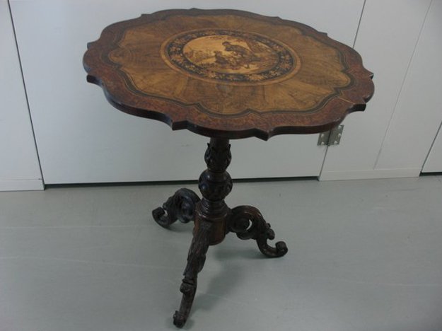CONTINENTAL MARQUETRY TEA TABLE: 19th Century, with a pedestal base, the inlay showing a peg legged man with a child, h. 28" d. 26"