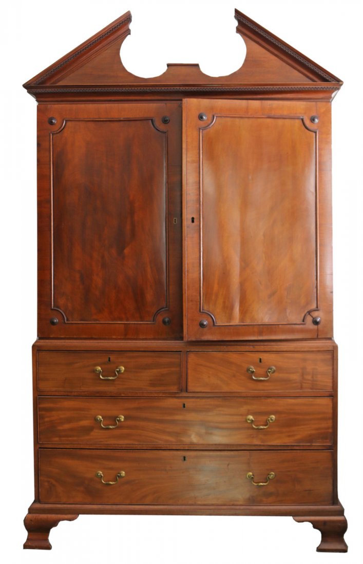 GEORGE III MAHOGANY LINEN PRESS: early 19th Century, 3-piece construction, the broken pediment over dbl. doors opening to pullout shelves, over 2 1/2 drawers over 3-full width drawers w/cock beading and orig. pulls, the whole on ogee