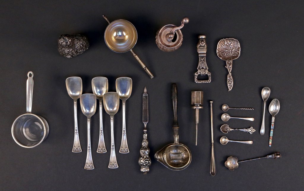 (22pc) MISC. LOT OF TABLE SILVER: Including 5 Austrian jelly spoons, a strainer with wooden handle, 5 salt spoons, 2 sugar spoons, a pepper grinder, a wine spigot, a wisk, an Aztec bottle opener, a file, a strainer with wooden handle,