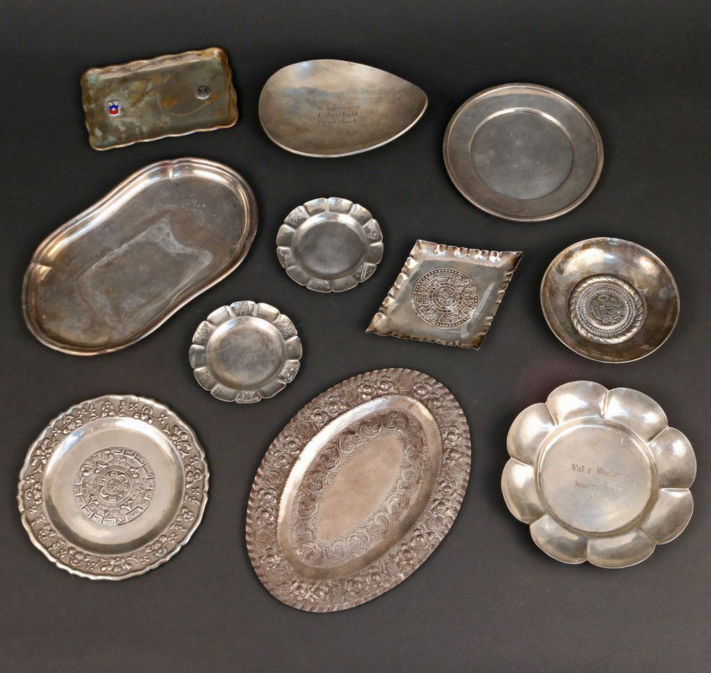 (11pc) MEXICAN SILVER TRAYS: Incl. a spratling flower head tray, 6-1/2"; an oval tray chased in repousse, 9-1/4"; a footed egg shaped tray; two 4" flower head form coasters; a diamond shaped ashtray; a Peruvian circular ashtray;
