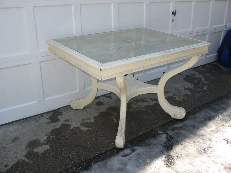 DINING TABLE WITH INSET ETCHED GLASS TOP: mid 20th Century, the top with sunburst motif, resting on 4-incurved legs with leaf carving on the feet and attached by lower shelf, h. 30", l. 48", d. 36"