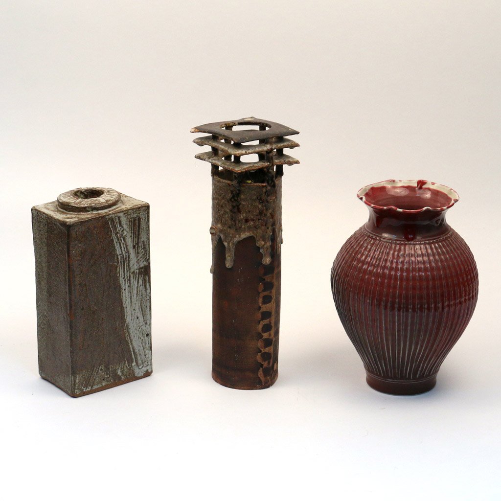 (3pc) EARTHENWARE GLAZED VASES: 20th Century, Ramon Elozua (German, 1947-) A cylindrical vase with a canvas texture signed and dated 1976; a block form vase sgd. "J. Land"," a baluster form red vase with flutes signed indistinctly a