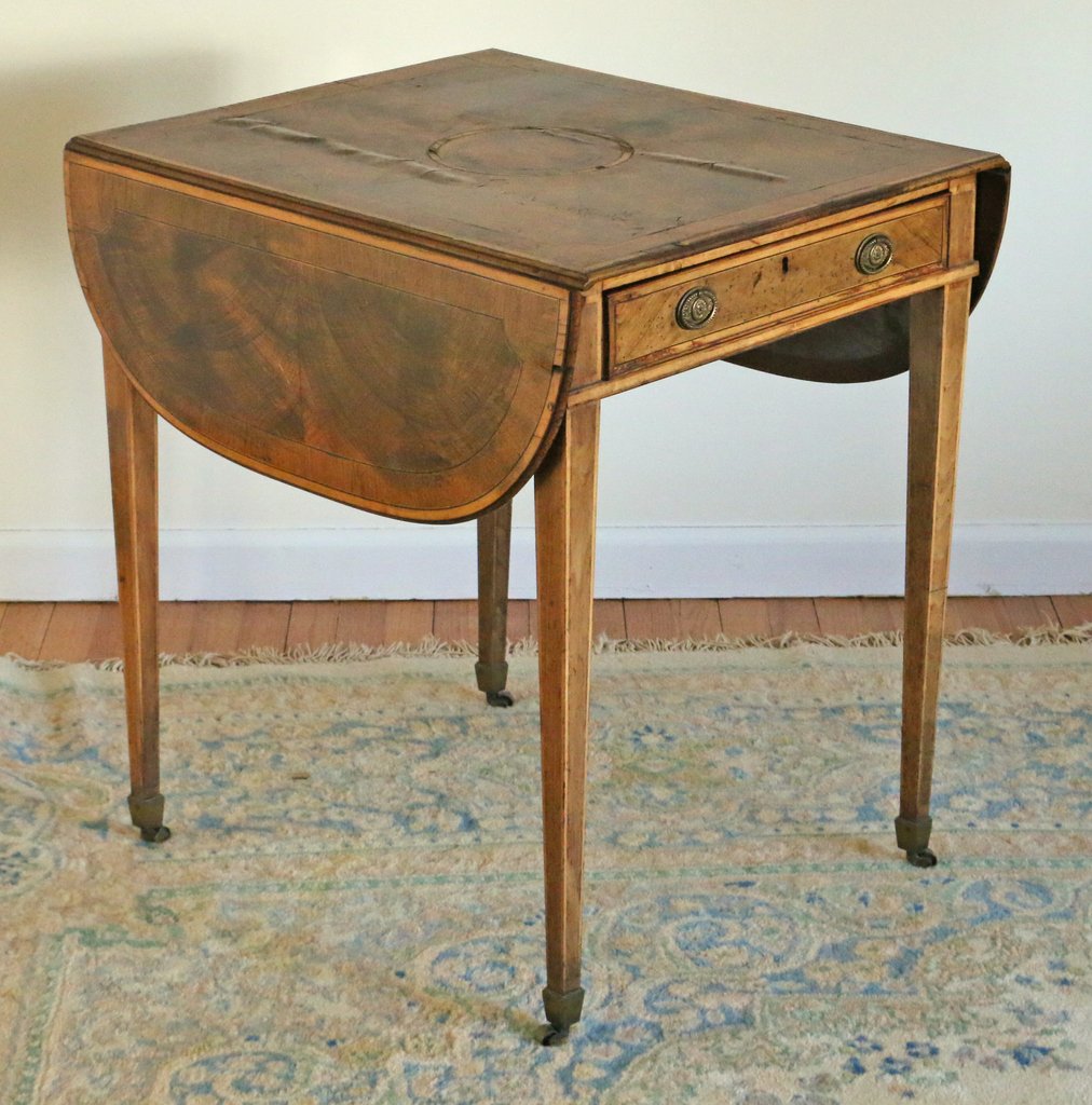 SHERATON INLAID ELM PEMBROKE TABLE: with a crossbanded top and sides, h. 28 1/2", w. 23", d. 27"; veneer losses and with raised areas on top, worm damage