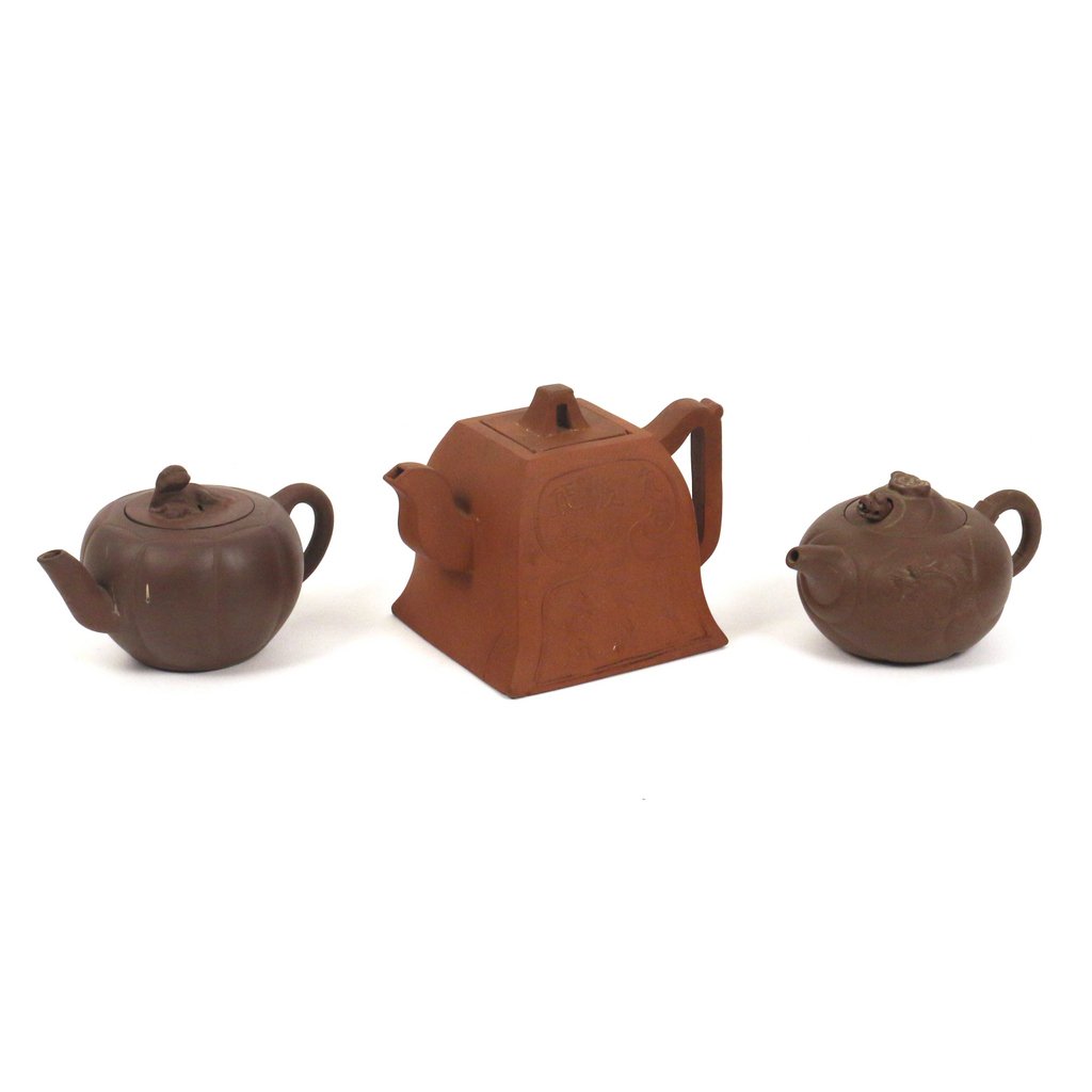 (3pc) CHINESE YIXING POTTERY TEAPOTS: including one of shaped square form, h. 4 1/4 in, with two-character mark under lid and a seal mark on base (with large hairline across bottom and partially up the sides); one with carved dragons on e