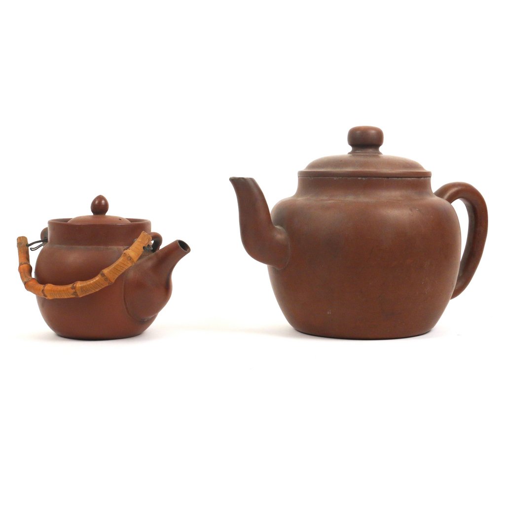 (2pc) TWO LARGE CHINESE YIXING POTTERY: including a kettle / wine ewer, h. 7 3/4 w. 11 1/2 in., with two seal marks on base; and a teapot with a fitted strainer and a bamboo handle, h. 5 in., no apparent mark