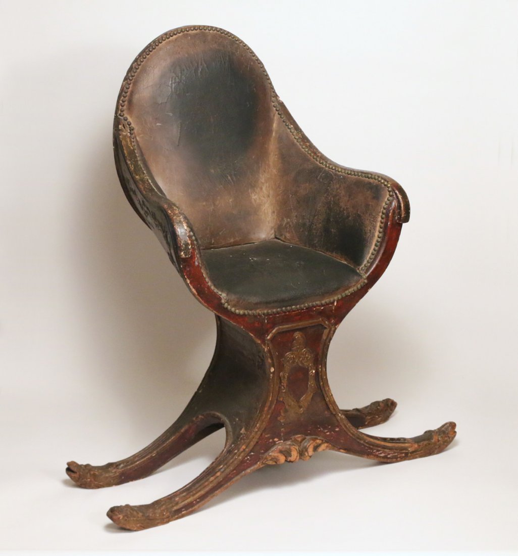 BARBARA ADRIAN'S WORK (GONDOLA) CHAIR: an 18th/early 19th Century Venetian gondola chair, used by Barbara Adrian (American, 1931-2014) as her primary work chair when painting, the parcel gilt carved back and sides in old Spanish brown pain