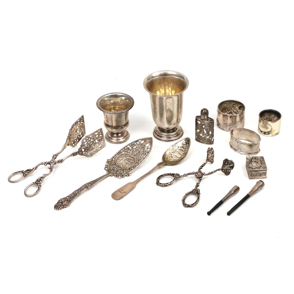 LOT OF "800" SILVER: Including two pairs of tongs, a pierced spade, a teaspoon, three napkin rings, a patch box, two footed cups, a small silver overlay perfume bottle, and two cigarette holders; tot. weighable appx. 12 t
