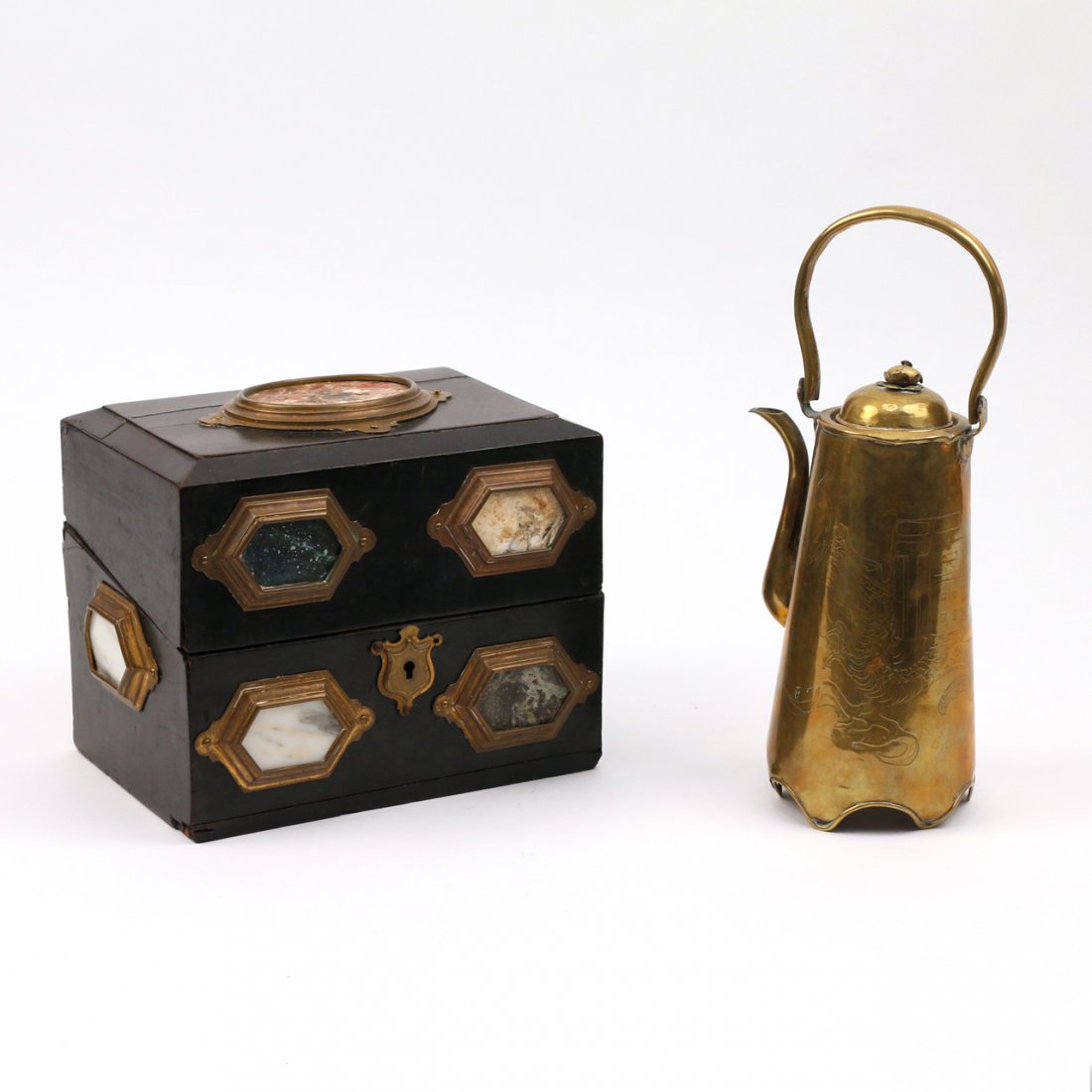 VALUABLES BOX AND BRASS PITCHER: Including a brass pitcher with a bail handle h. 10 in.; and a continental ebony wood valuables box inset with hexagonal marble plaques, h. 6-1/2, w. 8-1/4, d. 5-3/4 in.; n.b. there are age separations