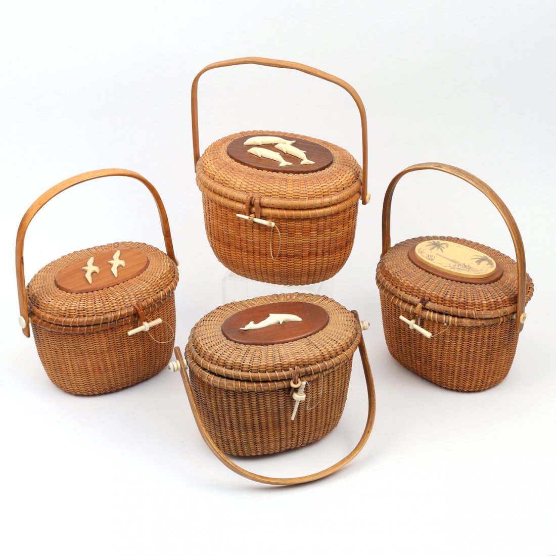(4pc) NANTUCKET BASKET PURSES: including one with an applied dolphin on the lid, sgd. 'Jose Arroyo 72'', 6 1/2 x 11 x 7 in.; one with three applied dolphins on the lid, sgd. 'Jose Hartes' (?), 7 1/2 x 10 x 8 in.; one with two appli