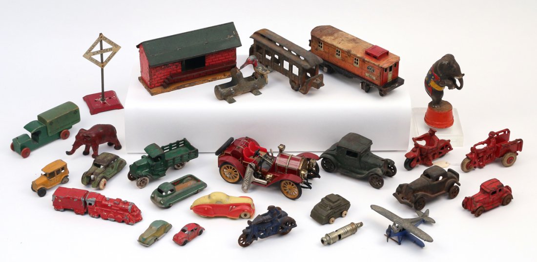 (27pc) MISC. ANTIQUE CAST IRON, TIN, & WOOD TOYS: including 1 Schuco 'Mercer'; 3 motorcyclists; 1 elephant still bank; 8 misc. cars; 3 misc. wagons; 1 plane; 1 tank; 1 whistle; 1 small engine with 1 matching coal car; 1 elephant; 1 crossing sign; 1 w