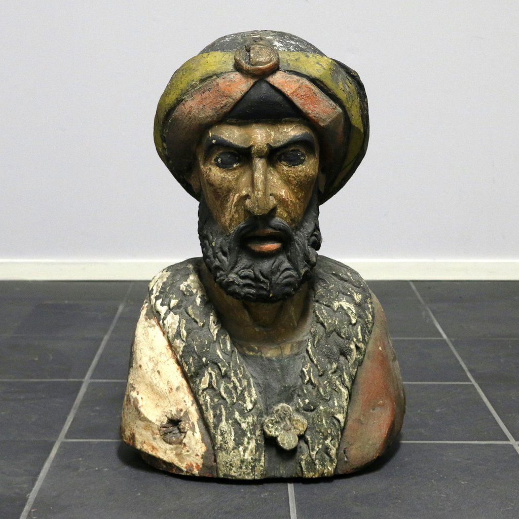 CARVED POLYCHROME BUST OF A TURK: late 19th/early 20th Century, probably an old Cigar Store advertising figure, in old paint, h. 21 in., Provenance: with Winchester Antiques, Winchester, MA; purchased from the above by the present own
