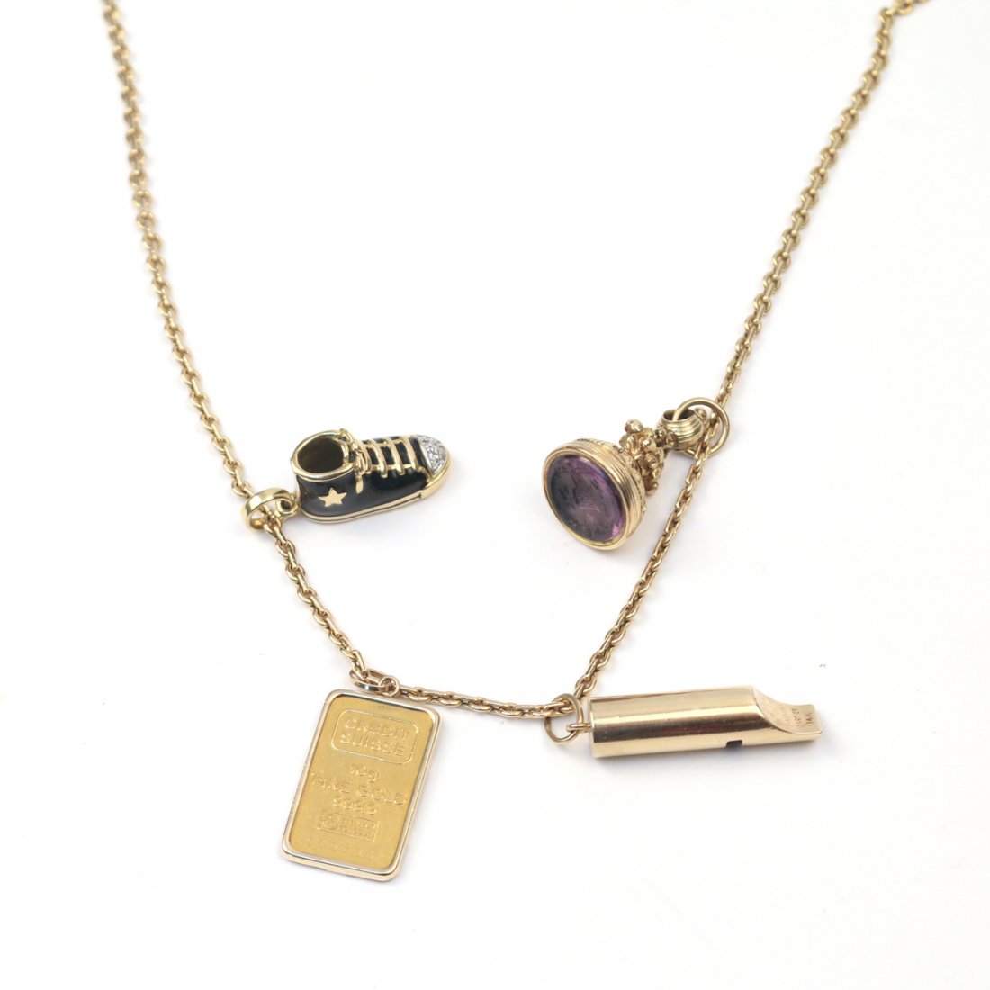 14k GOLD NECKLACE WITH FOUR GOLD CHARMS: the chain link necklace, 24 in. long, 6.2 gms, with a 10g Credit Suisse pure gold bar, ; a Cartier 14k gold whistle, 2.7 gms; an 18k gold, black enamel, and melee diamond sneaker; and a chased gold (u