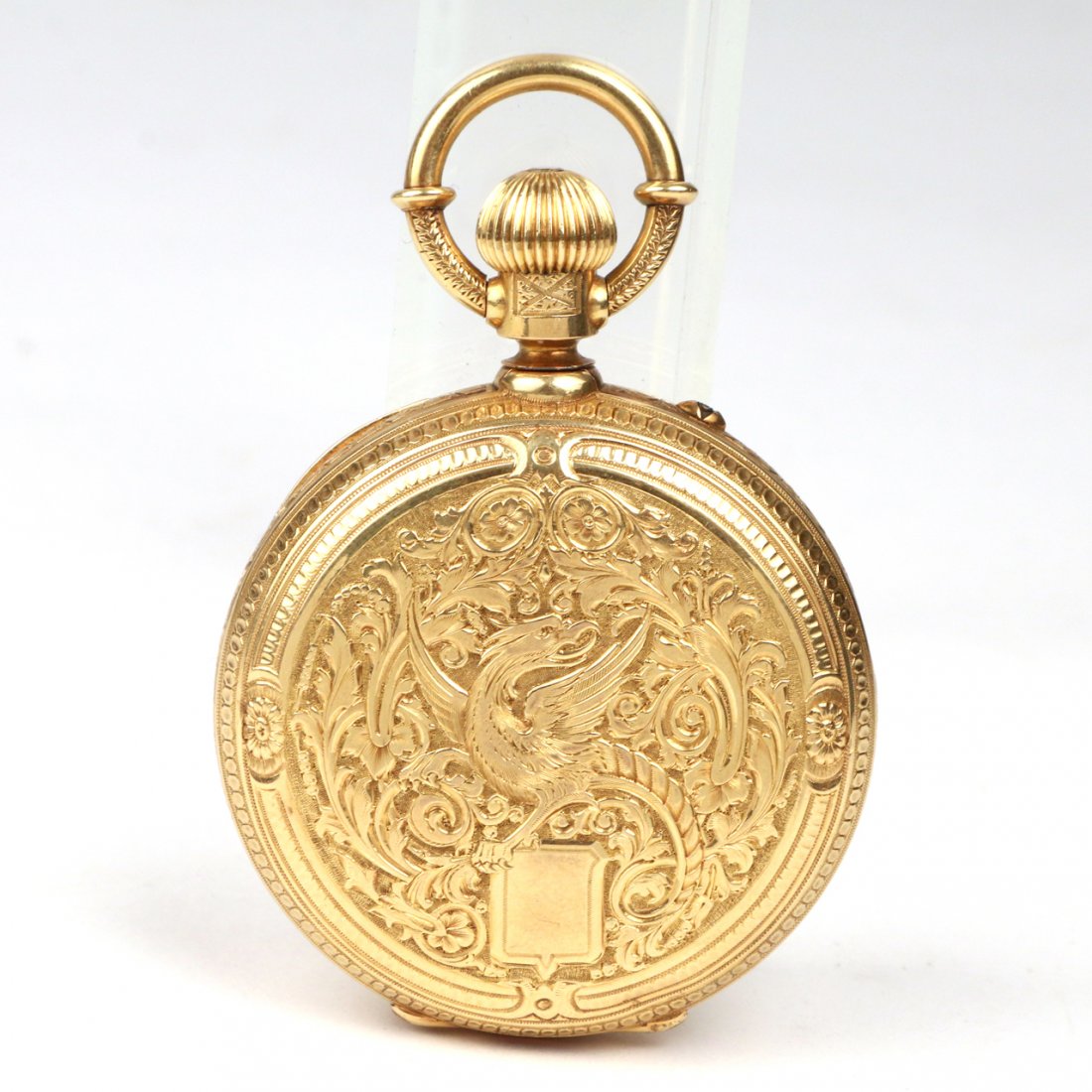 18k YELLOW GOLD POCKET WATCH: c.1860, the case chased on both sides with a phoenix, flowers and leaves, the case marked "18k" in several places, sterling silver dial with applied gold surround, glass-covered 16-jewel movement with