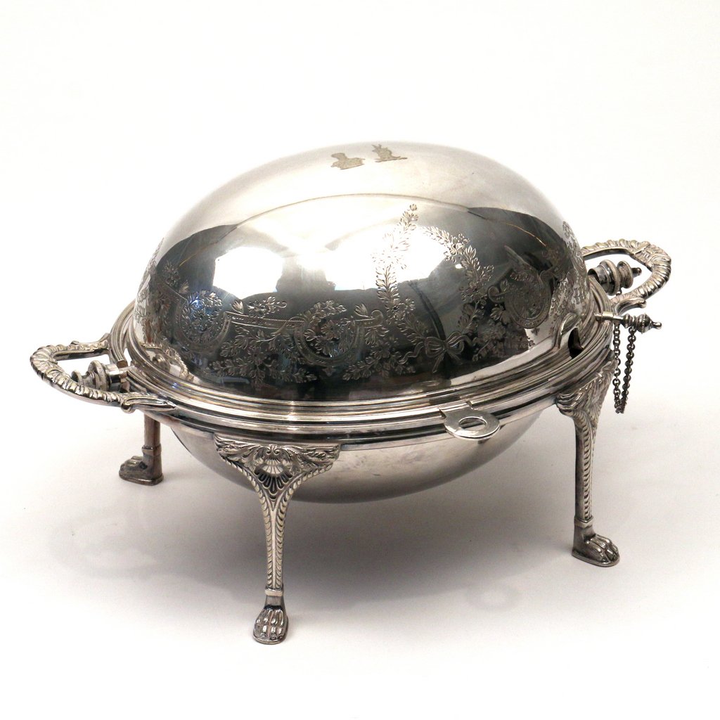 MAPPIN & WEBB'S SILVERPLATED CHAFFER: Of small size, the roll top decorated with flowers and vines and engraved with a bearded man in a crown and a horned goat, a pierced vegetable steam tray inside. Marked "Triple Deposit, London & Sheff
