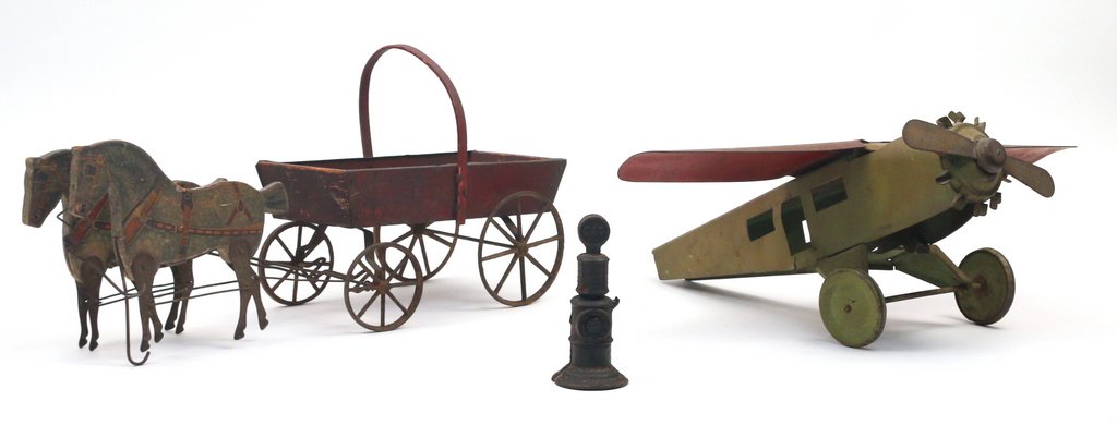 (3pc) ANTIQUE TOYS: Including a wire-connected articulated horse-drawn carriage l. 19 in., a high-wing radial toy plane with damage and missing empennage, and a cast iron gas pump with faded old paint, missing lever
