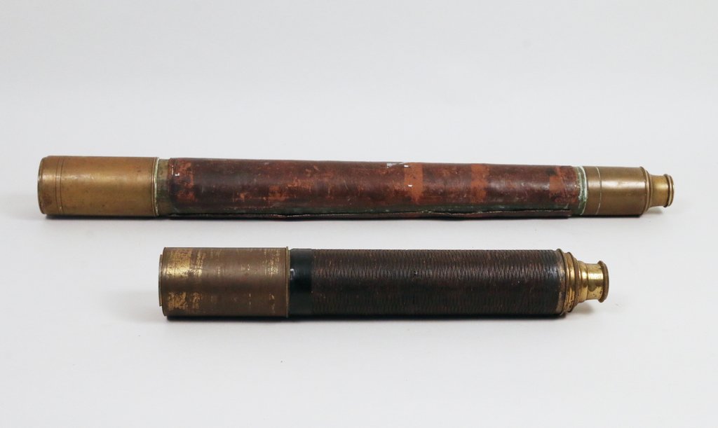 TWO ANTIQUE SPY GLASSES: Including a two-drawer spy glass signed indistincly '__ __ Dolland's/ __ London' (?), 26" closed, the leather split at the seam and shrunk; and a three-drawer spyglass signed 'Made for McAllister & Co