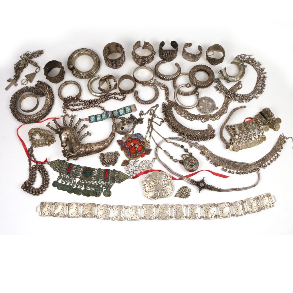 LOT OF MIDDLE EASTERN & INDIAN COSTUME JEWELRY: Composed of various metals; including several bangles, cuffs, elaborate belts, head ornaments, necklaces, etc. n.b.: many pieces appear to be silver, we have not tested them and they do not bear any s