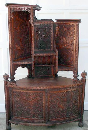 CHINESE CARVED CORNER ETAGERE: early 20th Century, 2pc. construction, upper section with shelves, lower with sliding double doors, overall carving of exotic birds and scroll leaf design, h. 65", w. 43", d. 18"