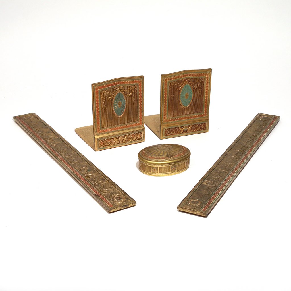 (5pc) TIFFANY STUDIOS GILT BRONZE DESK SET: (5pc) TIFFANY STUDIOS GILT BRONZE DESK SETin the 'Adams' pattern, all pieces with original coloring, including a pair of bookends, h. 6 in., two blotter-ends, 19-1/4 in., and an oval box