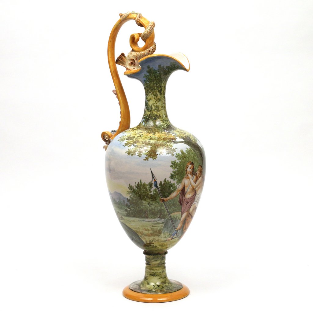 GINORI MAJOLICA EWER: GINORI MAJOLICA EWERItaly, early 20th Century, painted with a modeled handle having a dolphin and mask, the body painted with Venus and Adonis in a landscape, the base signed ‘Ginori / 30-1108’ an
