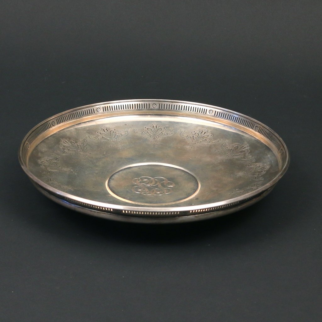 TOLE STERLING SILVER FOOTED TRAY: TOLE STERLING SILVER FOOTED TRAYcircular with a wreath design and pierced gallery form lip, monogrammed, 2 x 11 in.