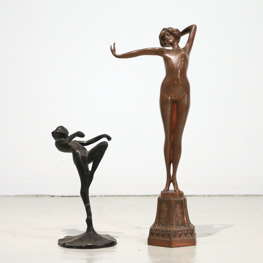 (2pc) ART DECO FEMALE SCULPTURES: (2pc) ART DECO FEMALE SCULPTURESincluding a copper-colored spelter female, h. 16"; and Frank Art figure with black patina, marked 'Frank Art 1922', h. 8-1/2 in.