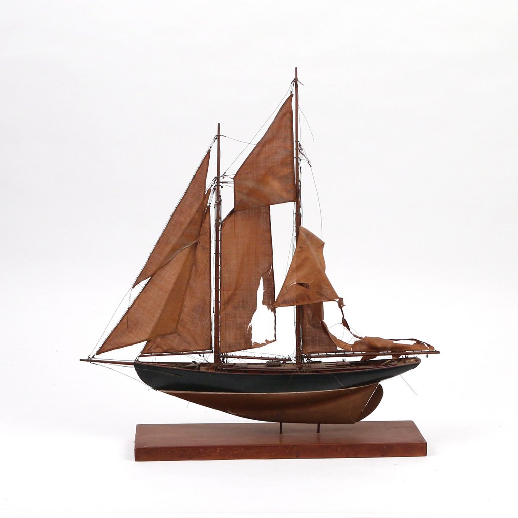 MODEL OF A SCOONER: MODEL OF A SCOONERearly 20th Century, with two masts, 18 x 17 in. (the model), cloth sails with damage