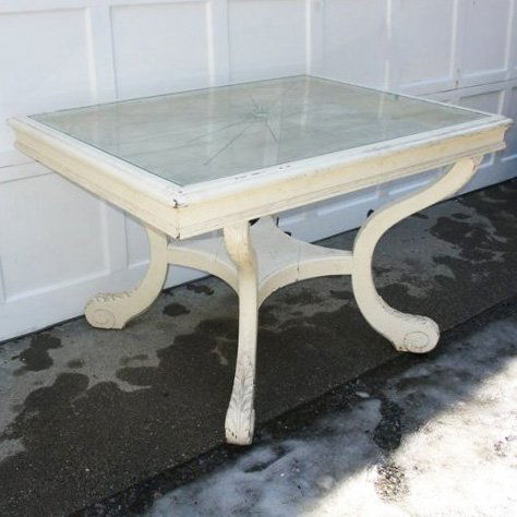 DINING TABLE WITH INSET ETCHED GLASS TOP: DINING TABLE WITH INSET ETCHED GLASS TOPmid 20th Century, the top with sunburst motif, resting on 4-incurved legs with leaf carving on the feet and attached by lower shelf, h. 30", l. 48", d. 36"