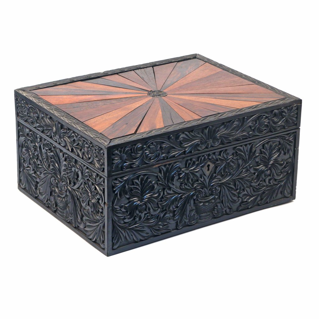 ANGLO-INDIAN SPECIMEN-WOOD CASKET: 19th or early 20th Century, the sides heavily carved with a vase issuing sprays of foliage, h. 8-1/2 w. 18 d. 13-3/4 in, some separations