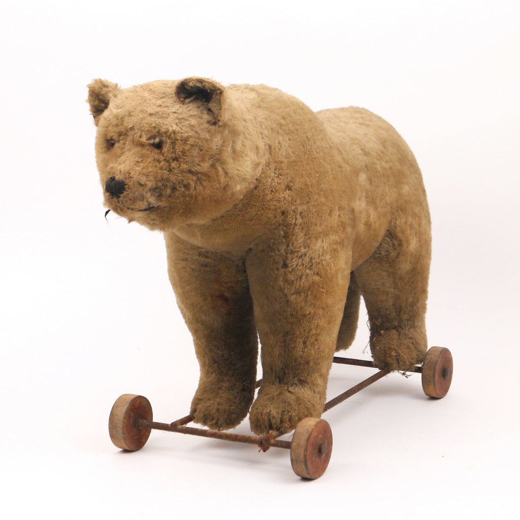 BEAR PULL-TOY: early 20th Century, with wooden wheels, h. 16-1/2 w. 22 d. 9-1/2 in.,Prov.: estate of Julie Swanston, Fairfield, CT