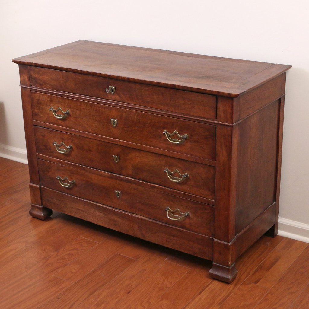 CONTINENTAL WALNUT CHEST OF DRAWERS: mid 19th Century, with four full drawers having brass escutcheon lock-plates, h. 34-1/2 w. 49-1/2 d. 20-1/2 in.