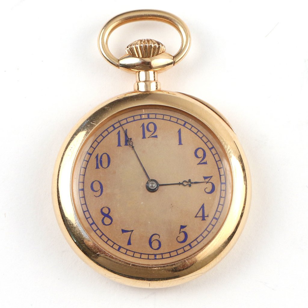 TIFFANY & CO. 18K GOLD LADY’S LAPEL WATCH: Having an engraved case and blue enameled roman numerals and chapter ring, no. 82219, 35mm case diameter, total weight appx. 47g