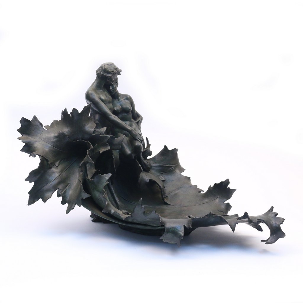 TIFFANY STUDIOS BRONZE FIGURAL GROUP: A man and a woman entwined in an oak leaf cresting vide-poche, no apparent artist signature, stamped 'TIFFANY STUDIOS / NEW YORK' and 08818, h. 14 w. 25 d. 15 in. (appx.)