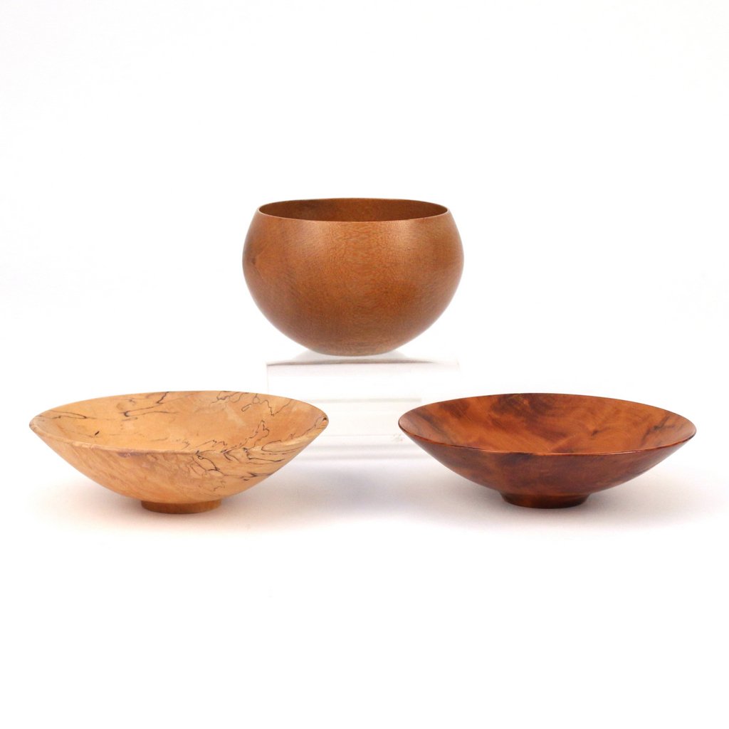 (3pc) BOB STOCKSDALE & AL STIRT: including a Bob Stocksdale globular bowl in macadamia wood from Hawaii, signed and dated 1982, h. 3 d. 4-3/4 in.; a Bob Stocksdale low-form bowl in thuya burl wood from Morocco, signed and dated 1983,
