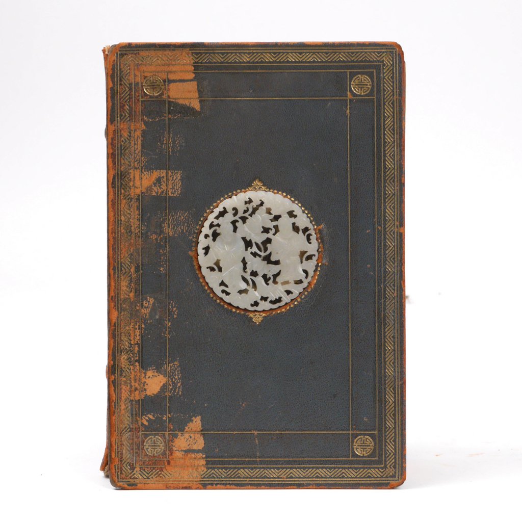 [FANCY BINDINGS] YAMANAKA & CO.: Webster's dictionary bound in full green leather with an inset carved jade plaque (d. 2-3/8 in.) on the front, interior of back board signed "Yamanaka & Co. / 650 5th Ave., New York"