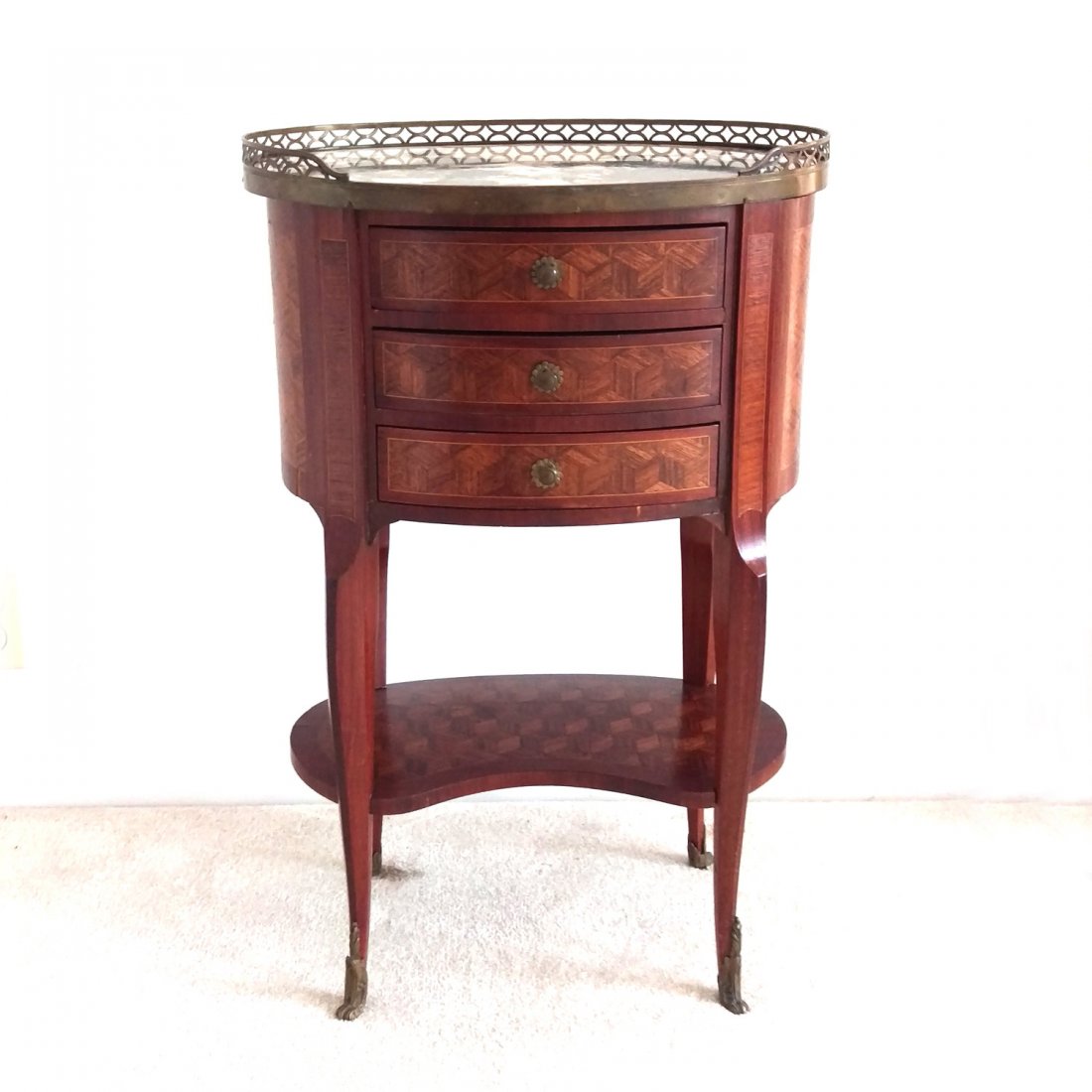LOUIS XV TABLE EN HARICOT: 19th C. or earlier, having parquetry inlay, a marble top within ¾ openwork ormolu gallery over three drawers with parquetry inlay conforming lower shelf, w. 18”, d. 13”, h. 28”