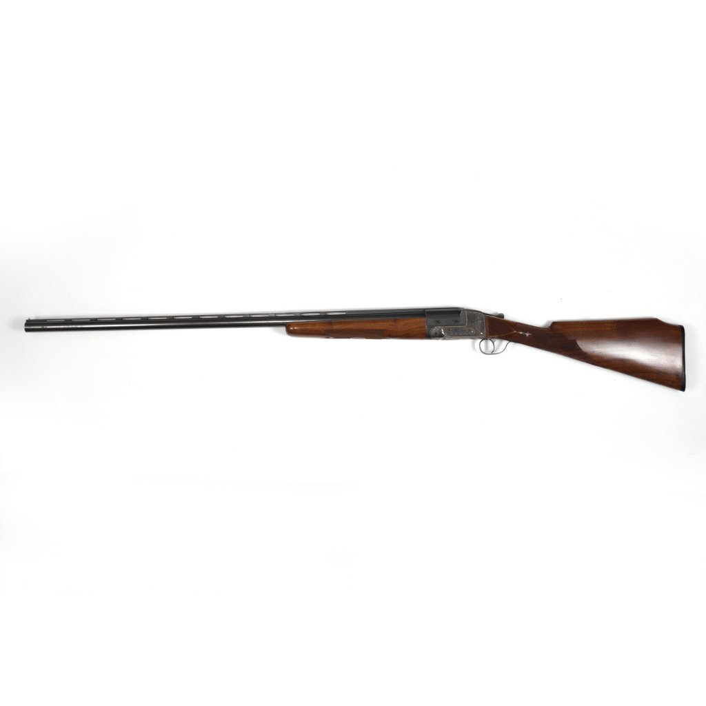 ENGRAVED ITHACA GUN CO. SHOTGUN: "Single Barrel Trap" 12 gauge breech-loading (serial #238354 [range 259,xxxT]), 34in. Flues barrel, receiver engraved with dogs, birds and scrolls, having a checkered walnut beaver-tail fore-end and s