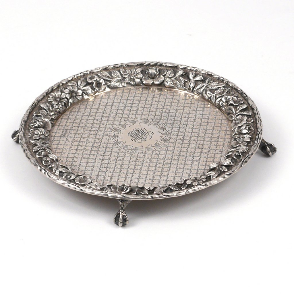 S. KIRK & SON STERLING SILVER SALVER: with a floral border in repousse and a diaper-pattern center, d. 7 in., 6 toz