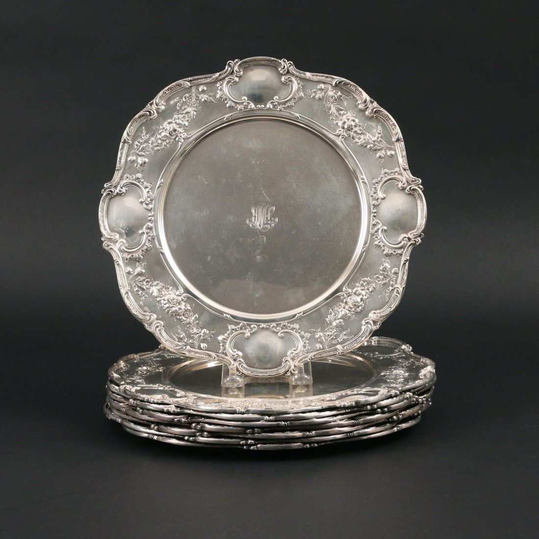 (8pc) GORHAM ROCOCO STERLING CHARGERS: Each decorated with cartouches, roses, leaves, ribbons, and a shaped S scroll edge, monogrammed "AMC" on front with "January 30th 1894-1919", six plates with 1916 date mark, two plates with 1923 date 