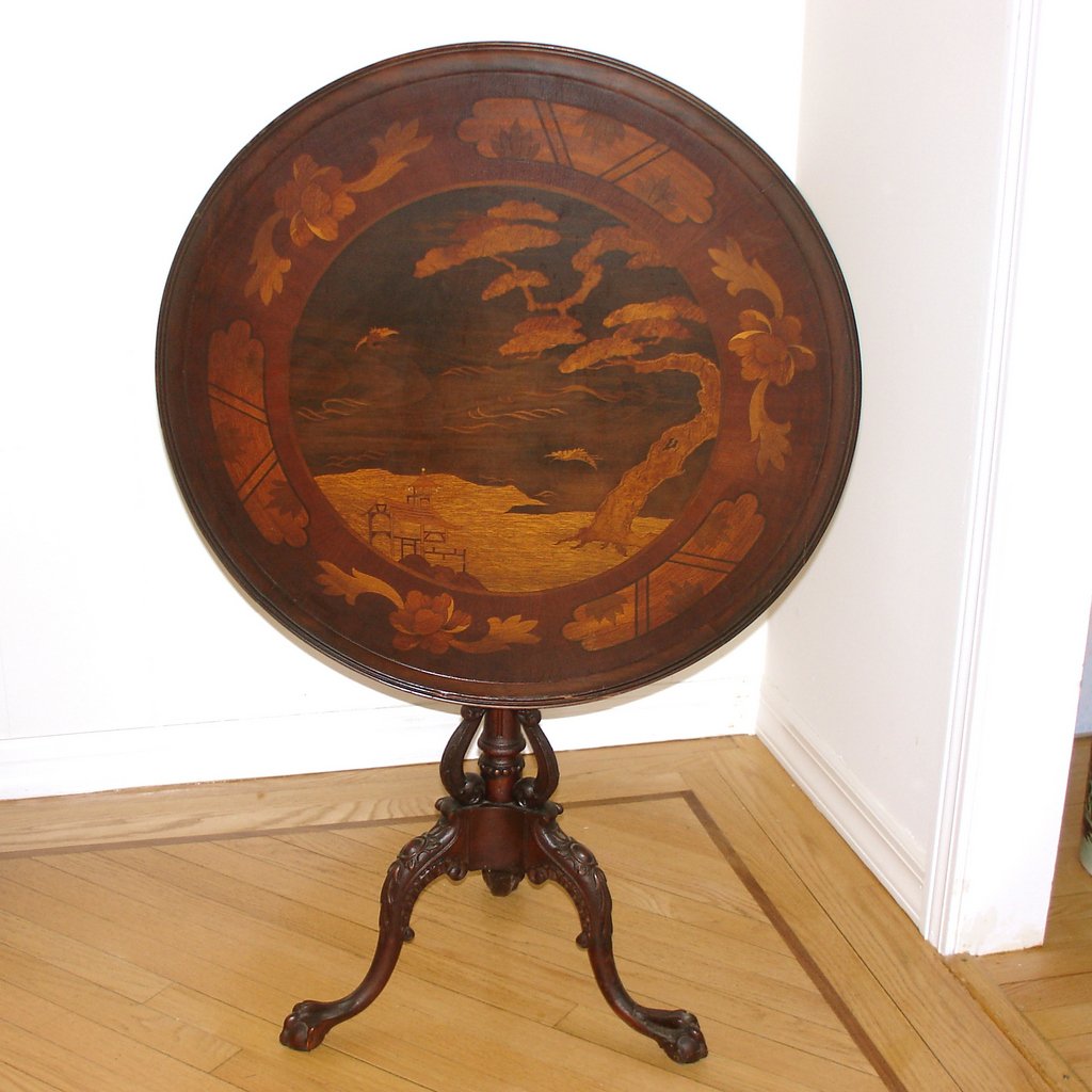 CONTINENTAL MARQUETRY TEA TABLE: early 20th Century, the dish shaped top with a landscape scene in the Chinese taste, the carved standard with bird-form supports over a tripod base ending in ball-and-claw feet, h. 28 d. 26-1/2 in.