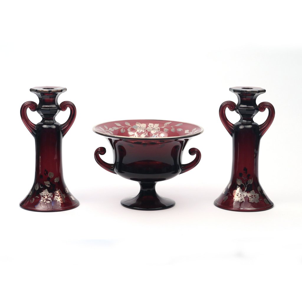 (3pc) CONTINENTAL GLASS GARNITURE: purple colored glass with silver overlay, including two candlesticks, h 10 in. and a center bowl, 6-3/4 x 9-1/2 in.